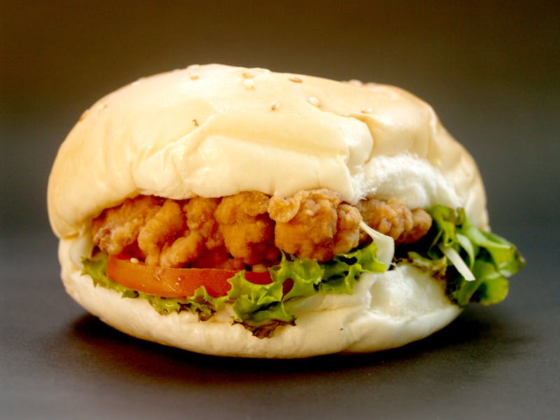Loaded starbird chicken burger stacked with toppings